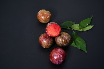 Fresh plums on a black background
