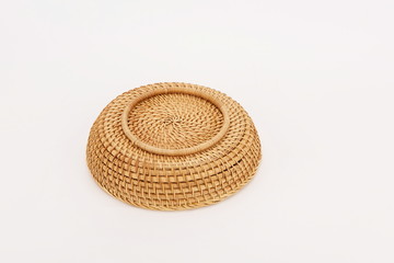 A woven bamboo basket isolated against a white background