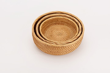 Three woven bamboo baskets against a white background.