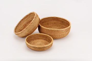 Three woven bamboo baskets against a white background.