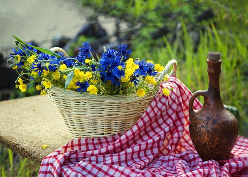 Still life outdoor with flowers in the basket