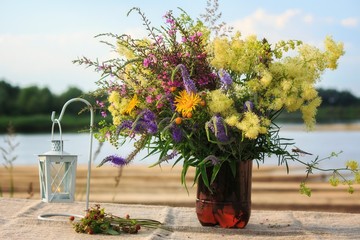 Bouquet of delicate field's flowers on the water background