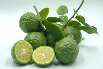 Fresh bergamot fruit with leaf on white background.