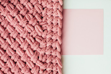 Texture of pink knit blanket. Plaid merino wool.