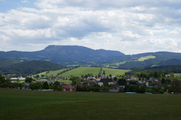 Fototapeta na wymiar Field and mountains, beautiful landscape in Austria in a village.