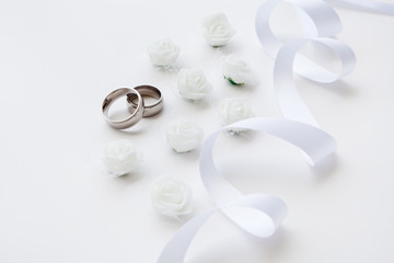 Wedding rings are decorated with a ribbon with copy space. Concept backgrounds for weddings.