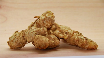 Fresh organic ginger at fresh market on wooden background