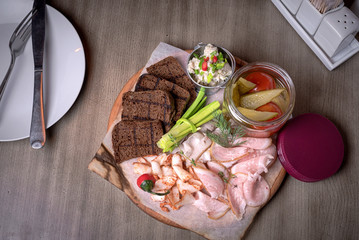 Lard with seasonings, fried bread, onions, sauces, balk and pickled cucumbers with tomatoes. food set. For the menu of cafe. wooden table. side view. macro photo