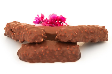 Chocolate candies and magenta flowers