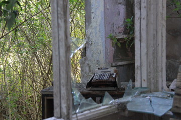 broken typewriter through a broken window