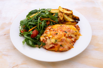 Chicken Parmesan Baked in Tomato Sauce with cheese, chips