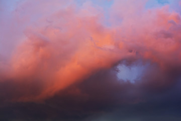 Dramatic sky with bright red and dark blue stormy clouds. Nature background. Soft focus