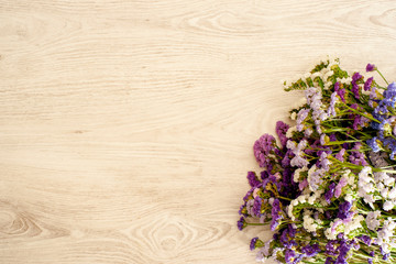 Decorative background made with natural wood and composition of statice flowers