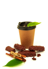 Chocolate candies, paper glass, cinnamon, anise and green leaves