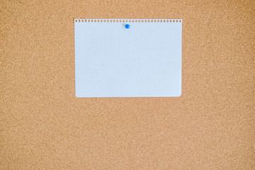 Blank note paper on cork board.