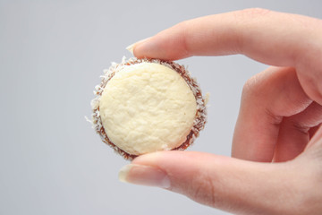 Alfajor on hands caramel cookie