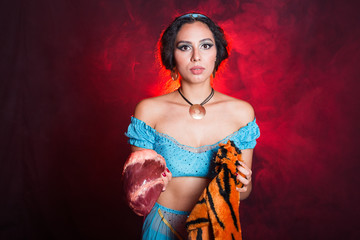 Stop animal killing concept - Pretty girl show animal skin and raw meat that she wants to tell someone don't kill animals or stopped violence against animal.