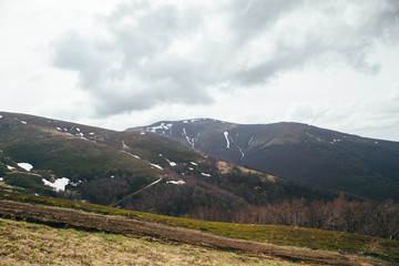 Spring in mountains. Beautiful mountain landscape with snow on the north slope