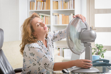 Woman suffers from heat in the office or at home