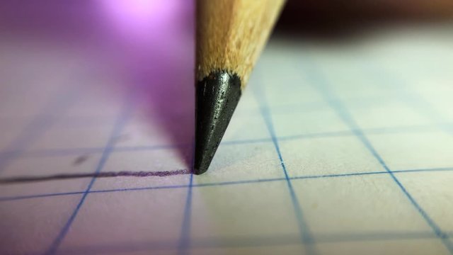 Super macro shot of pencil drawing a line