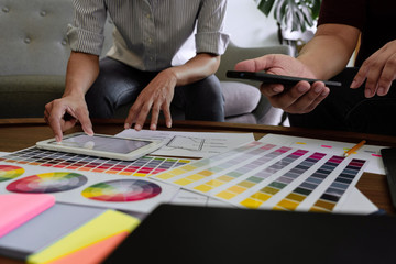 Fototapeta premium Creative Team Meeting to Discuss the Terms of Use of Original Product Colors for Product Design in Coworking Space, Teamwork modern Cooperation concept.