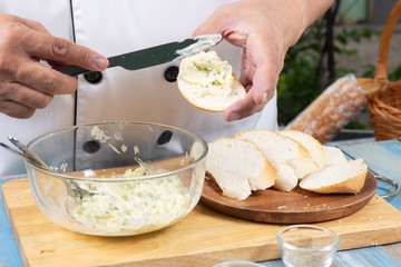 Chef spread garlic butter on slice bread /