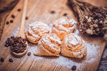 Homemade cake on a rustic wooden table with coffee beans.