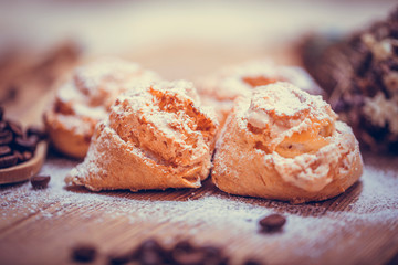 Natural baked coconut cookies or cocoanut macaroons on wooden plate. Homemade diet biscuits on rustic background.