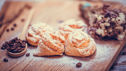 Natural baked coconut cookies or cocoanut macaroons on wooden plate. Homemade diet biscuits on rustic background.