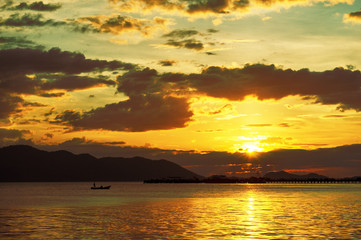 Small Fishing Boat Moving to Harbor When The Sunset