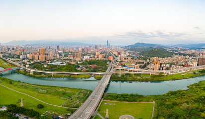 Fototapeta premium Taipei City Aerial View - Asia business concept image, panoramic modern cityscape building bird’s eye view under sunrise and morning blue bright sky, shot in Taipei, Taiwan