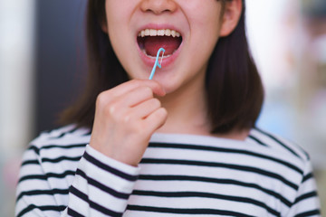 Japanese girl use dental floss in the wash room