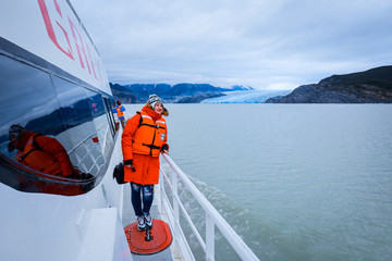 Glacier Gray, Chile - March 09, 2020: Happy and Smiling Man Tourist on the Boat to Glacier Gray 