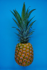 Fresh sweet Ripe Pineapple on a blue background, close-up.