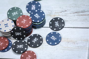 Poker playing chips on a wooden table . Online gambling. Addiction. Falling poker chips. Losing money