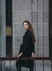 Stylish lady in elegant black coat