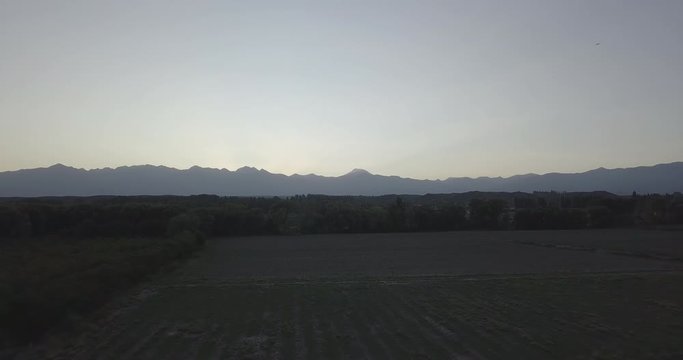 Ungraded, Forward aerial flight towards mountain range of Cordillera de los Andes during golden hour. Drone, 4K. 
Valle de Uco, Tupungato, Mendoza, Patagonia, Argentina