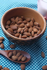 Top view of almond nuts and milk on table 