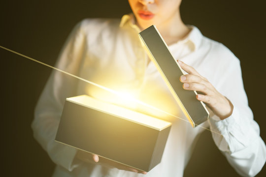 Woman Opening A Box With Gold Light Mean Something Exciting Inside.