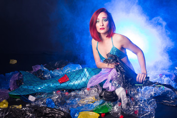 Fototapeta na wymiar Sea plastic pollution concept. Mermaid in the ocean. Plastic is everywhere. Environmental protection.