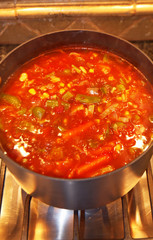A delicious pot of homemade vegetable soup simmering on the stove.