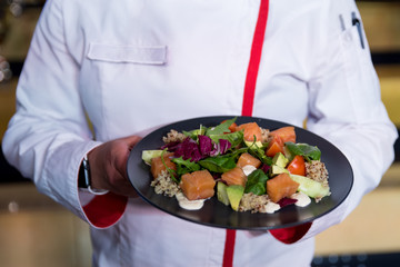 Cooking a salad, a salad of fresh vegetables with olive oil.