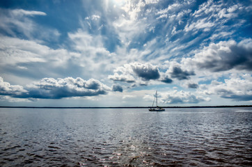 A sailboat in Winyah bay with a dramatic sky.