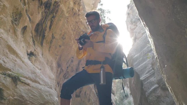 Traveler taking photos of mountain canyon during trip