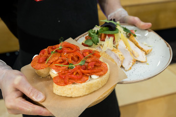 Chef preparing caprese bruschetta in the kitchen