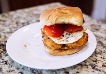 Home made chicken nugget hamburger in a white plate