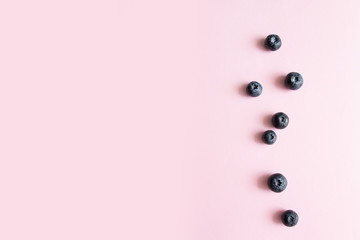 Top view of ripe blueberries on a pink background. Proper Diet Healthy Eating. Minimal composition