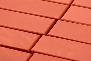 A stack of bricks for construction, hollow brick. Material for construction and repair. Clay brick, brick texture, preparation for the construction process