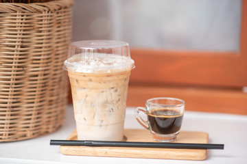 Iced coffee in a clear glass that can see the ice inside the glass And was placed in a coffee shop