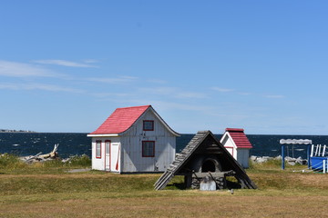 Fototapeta na wymiar Red and white cabins by the seaside